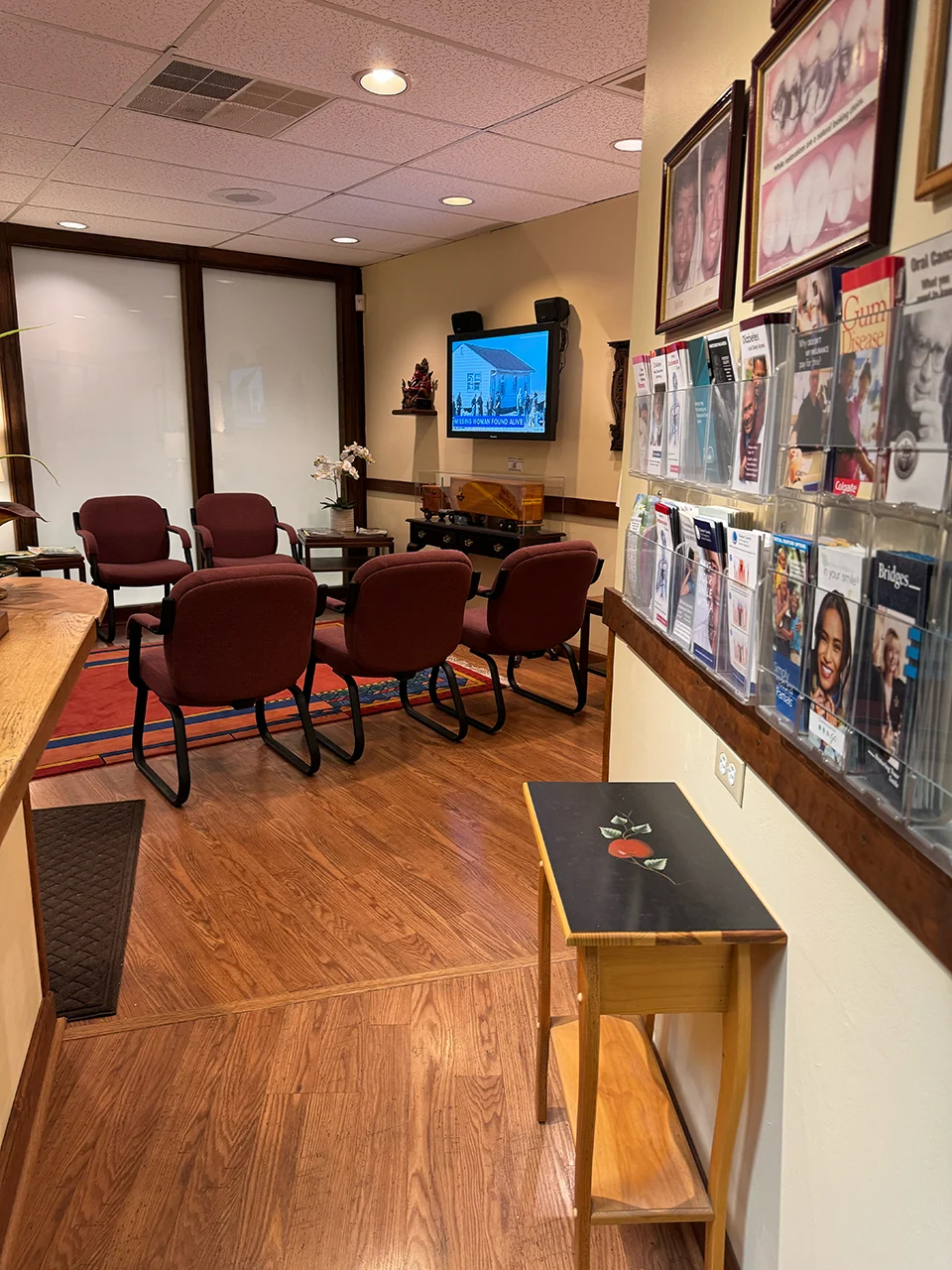 Welcoming dental office waiting area with comfortable chairs, informational brochures, and a TV displaying patient-friendly content, emphasizing a family-centered atmosphere in West Chester, PA.