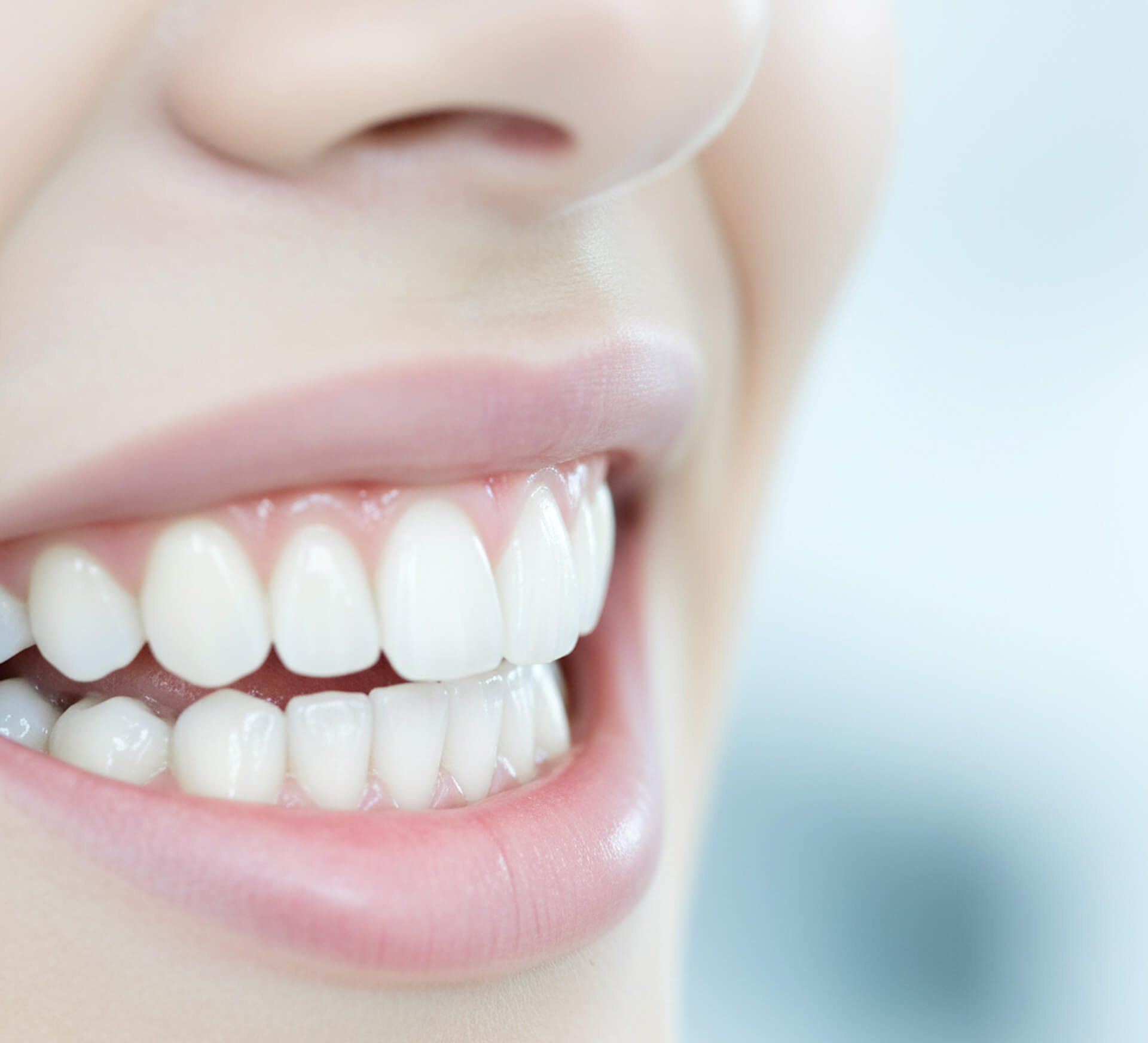 Close-up of a smiling person showcasing bright, healthy teeth, emphasizing the results of professional dental cleanings at M.Y. Family Dentistry.