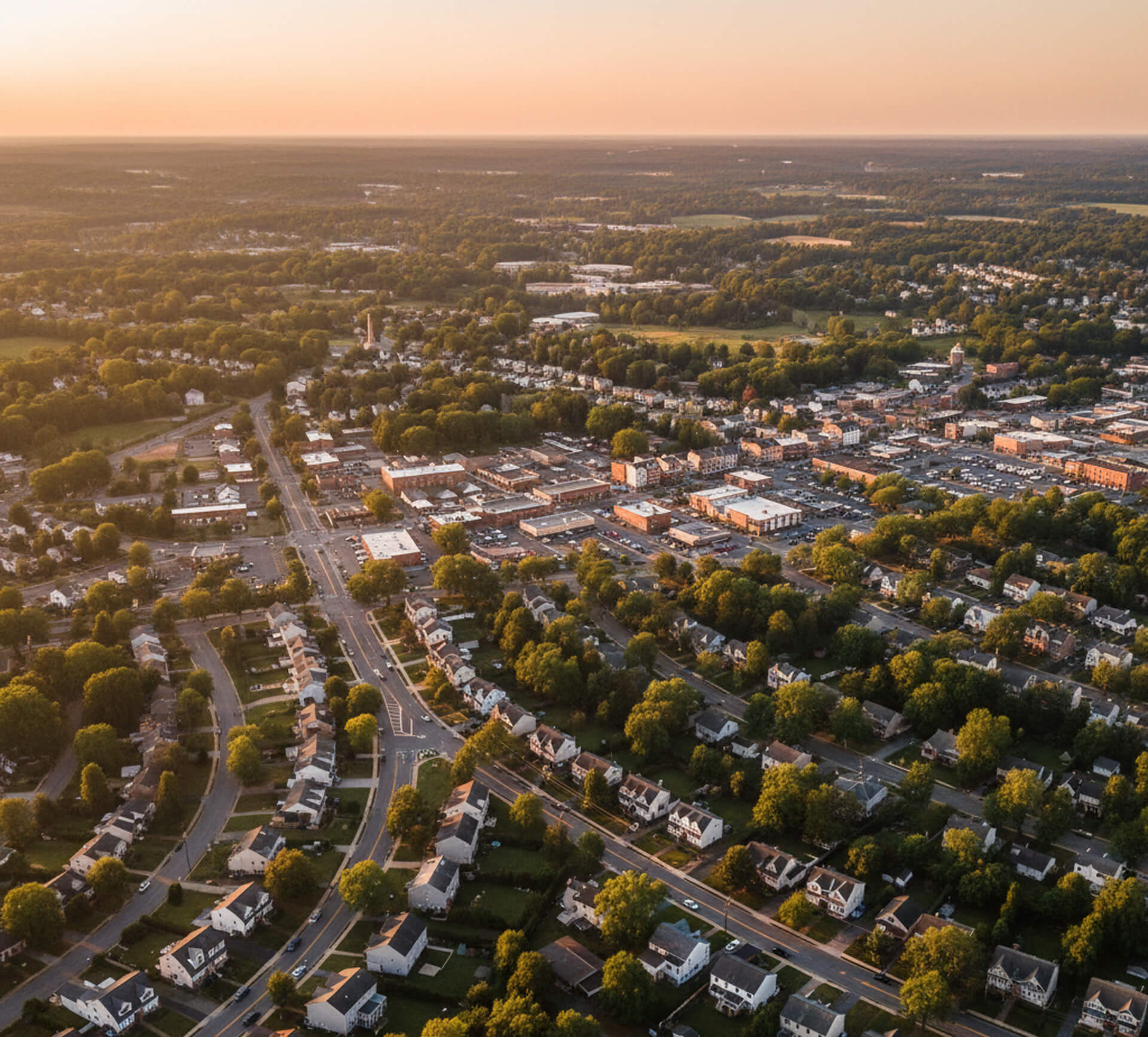 Aerial view of Downingtown, PA, showcasing residential neighborhoods and commercial areas, emphasizing the community's accessibility and charm for families seeking dental care.