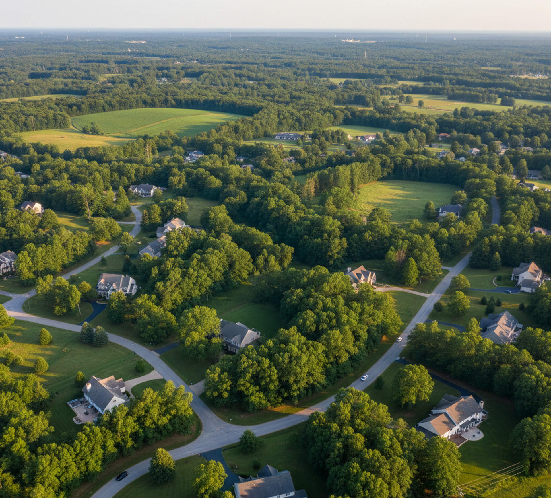 Aerial view of a scenic suburban neighborhood in Glen Mills, PA, featuring lush greenery, winding roads, and residential homes, highlighting the family-friendly environment near MY Family Dentistry.