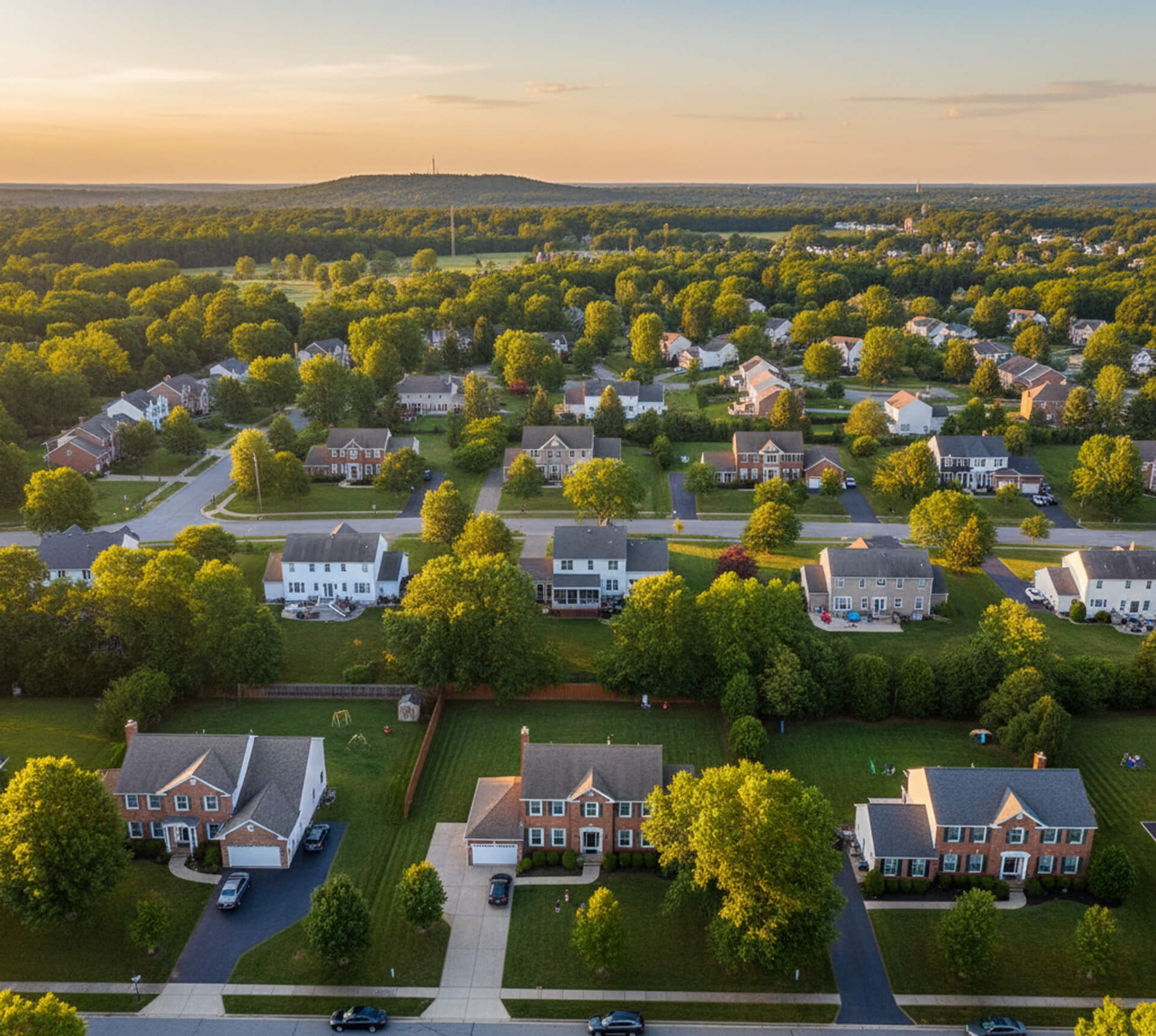 Aerial view of suburban neighborhood in Newtown Square, PA, showcasing family homes and lush greenery, reflecting a welcoming community atmosphere.