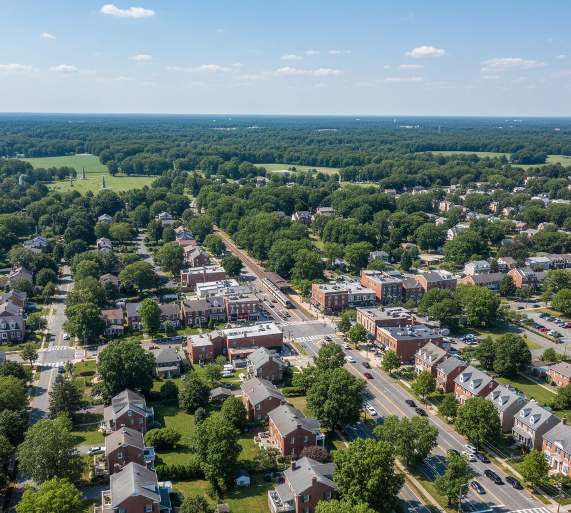 Aerial view of residential neighborhood in Paoli, PA, showcasing tree-lined streets, homes, and local businesses, highlighting the community atmosphere relevant to MY Family Dentistry's family-centered dental care services.