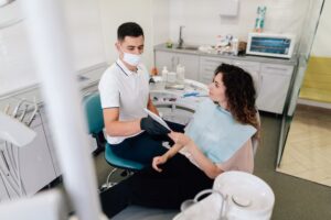 Dentist giving mirror to patient in the office